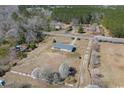 An aerial view of the home and surrounding acreage shows the private setting and distance to nearby highway at 1651 Circle Bay Dr., Longs, SC 29568