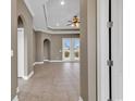 A light-filled foyer with tiled flooring, high ceilings, and arched doorways leading to other rooms at 169 Northside Dr., Little River, SC 29566