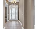 Spacious entry foyer featuring an ornate glass front door, tile floors, and neutral wall paint at 169 Northside Dr., Little River, SC 29566