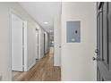 Bright hallway with wood-look floors leads to various rooms, showcasing the home's layout and design at 1870 Auburn Ln. # 21C, Surfside Beach, SC 29575