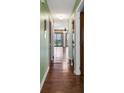 Hallway with beautiful hardwood floors leading to bright living space with sliding glass doors at 1881 Colony Dr. # 8-P, Surfside Beach, SC 29575