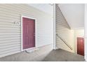 Condo entrance featuring a red front door, with the unit number 201, and a staircase at 2070 Cross Gate Blvd. # 201, Surfside Beach, SC 29575