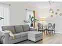 Inviting living room with wood flooring, light neutral decor, and contemporary dining set at 2070 Cross Gate Blvd. # 201, Surfside Beach, SC 29575