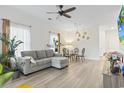 Sunlit living room featuring wood floors, dining table, comfortable seating, and bright interior at 2070 Cross Gate Blvd. # 201, Surfside Beach, SC 29575