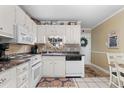 Kitchen with white cabinets, stainless steel appliances, and unique decorative elements for a cozy feel at 6302 N Ocean Blvd. # C2, North Myrtle Beach, SC 29582