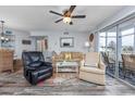 Inviting living room featuring comfortable seating, ceiling fan, and a sliding door to the screened-in porch at 8861 Cloister Dr. # F, Surfside Beach, SC 29575