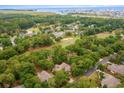 Aerial view of a neighborhood showcasing lush tree cover and a golf course at 921 Heshbon Dr., North Myrtle Beach, SC 29582