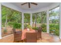 Cozy screened porch with a round table and comfortable wicker chairs overlooking a lush yard at 921 Heshbon Dr., North Myrtle Beach, SC 29582