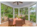 Cozy screened-in porch with tile flooring and comfortable seating for outdoor relaxation and entertaining at 921 Heshbon Dr., North Myrtle Beach, SC 29582