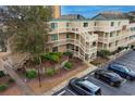 Aerial view of the exterior of a condominium complex with outside stairs and landscaping at 9661 Shore Dr. # A-21, Myrtle Beach, SC 29572