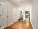 Bright entryway featuring hardwood floors, white walls, and a staircase leading to the upper level at 1024 Stanton Pl. # 1024, Myrtle Beach, SC 29579