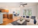 Open-concept living room with hardwood floors and bright natural light from large window at 1024 Stanton Pl. # 1024, Myrtle Beach, SC 29579