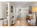Hallway view with hardwood floors leading to a staircase and a bathroom at 1024 Stanton Pl. # 1024, Myrtle Beach, SC 29579