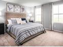 Relaxing main bedroom with a large bed, soft carpet, and plenty of natural light from two windows at 1174 Oak Meadow Dr., Conway, SC 29526