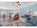 Open concept living room with view of kitchen and dining area with white kitchen cabinets at 1186 Pyxie Moss Dr., Little River, SC 29566
