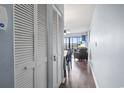 Hallway with blue walls, white trim and view of the living room with a view from the balcony at 123 N Dogwood St. # 107, Garden City Beach, SC 29576