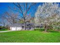 Charming single-story home featuring a well-manicured lawn, a welcoming front porch, and mature trees at 1278 Pinetucky Dr., Galivants Ferry, SC 29544