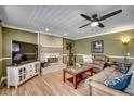Cozy living room with a fireplace, entertainment center, and comfortable seating, creating a relaxing space at 1278 Pinetucky Dr., Galivants Ferry, SC 29544