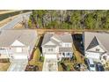 Aerial view of the home showcasing its location, landscaping, and proximity to a pond and surrounding trees at 204 Juniata Loop, Little River, SC 29566