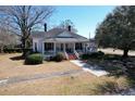 Sprawling front yard leading to a classic home with a wide, inviting front porch and mature trees at 213 S Farr Ave., Andrews, SC 29510