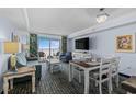 Inviting living space with a dining area, comfortable seating, and large windows showcasing the beautiful ocean views at 2201 S Ocean Blvd. # 1707, Myrtle Beach, SC 29577