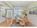 Bright dining room with large window, chandelier, and elegant wainscoting at 2212 Via Palma Dr., North Myrtle Beach, SC 29582