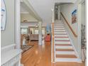 Inviting home foyer featuring hardwood floors, staircase, and open access to the living areas at 2212 Via Palma Dr., North Myrtle Beach, SC 29582
