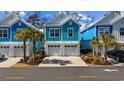 Charming teal two-story home with a double garage and palm trees at 2406 Seabreeze Pl., Myrtle Beach, SC 29577