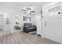 Bright living room features a blue sofa and a ceiling fan at 2406 Seabreeze Pl., Myrtle Beach, SC 29577