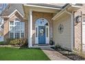 Close-up of the front door with brick columns, blue door with wreath, and sidelights at 2668 Corn Pile Rd., Myrtle Beach, SC 29588