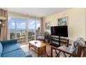Comfortable living room showcasing a large sliding door with ocean views and balcony access at 2701 S Ocean Blvd. # 202, North Myrtle Beach, SC 29582