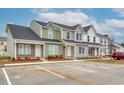 View of townhomes with neutral exteriors, brick accents, parking, and well-maintained landscaping at 2705 Mercer Dr. # 2705, Conway, SC 29526