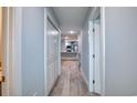 Bright hallway featuring wood-look tile, closet, and open view into the modern kitchen at 2705 Mercer Dr. # 2705, Conway, SC 29526