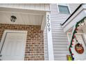 Close-up of townhouse entryway with brick facade, house number 2709, and decorative wreath at 2709 Mercer Dr. # 2709, Conway, SC 29526