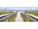 Picturesque beach access path with lush greenery leading to the ocean at 311 Cumberland Terrace Dr. # 7-F, Myrtle Beach, SC 29572