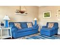 Comfortable living room with a blue sofa, floral pillows, and nautical decor, creating a beachy feel at 337 Sailors Ct., Myrtle Beach, SC 29577