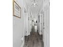 Bright hallway featuring light gray walls, multiple white doors, and modern lighting fixtures at 4520 N Plantation Harbour Dr. # F9, Little River, SC 29566