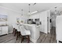 Modern kitchen with white cabinets, stainless steel appliances, a breakfast bar and stylish pendant lighting at 4520 N Plantation Harbour Dr. # F9, Little River, SC 29566