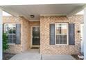 Home entrance framed by dark shutters and trimmed windows next to a modern security camera at 505 Hay Hill Ln. # B, Myrtle Beach, SC 29579