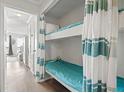 Cozy bunk beds tucked into the wall with blue covers, perfect for  at 6000 North Ocean Blvd. # 204, North Myrtle Beach, SC 29582