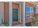 Inviting front entrance featuring a classic door with a wreath and a 'Welcome' mat at 7 Picket Fence Ln., Calabash, NC 28467