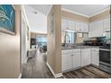Efficient kitchen with white cabinets and stainless steel features at 900 N Waccamaw Dr. # 301, Garden City Beach, SC 29576
