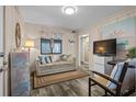 Cozy living room featuring a sofa, chair, and coastal decor accents at 900 N Waccamaw Dr. # 301, Garden City Beach, SC 29576