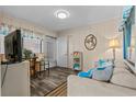 Comfortable living room with wood floors and access to outdoor entry at 900 N Waccamaw Dr. # 301, Garden City Beach, SC 29576