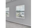 Light-filled room with neutral carpet and two windows with blinds at 108 Wagner Cir., Conway, SC 29526