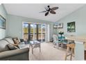 Cozy living room with sliding glass doors to balcony, comfortable seating, and dining area at 1230 St. George Ln. # F, Myrtle Beach, SC 29588