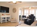 Living room with chair, television, ceiling fan, and wood-look flooring at 140 Spanish Oak Ct. # 1, Surfside Beach, SC 29575