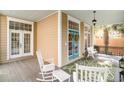 Charming front porch with rocking chairs, bench, and a colorful rug, creating a welcoming outdoor space at 1523 James Island Ave., North Myrtle Beach, SC 29582