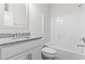 Bright bathroom featuring a granite countertop vanity and a shower-tub combination at 179 Crabapple Dr., Longs, SC 29568