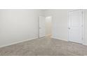 Neutral bedroom with plush carpet and a closet, offering a peaceful retreat at 179 Crabapple Dr., Longs, SC 29568